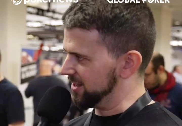 Keith Becker holding a microphone during an on-site poker interview