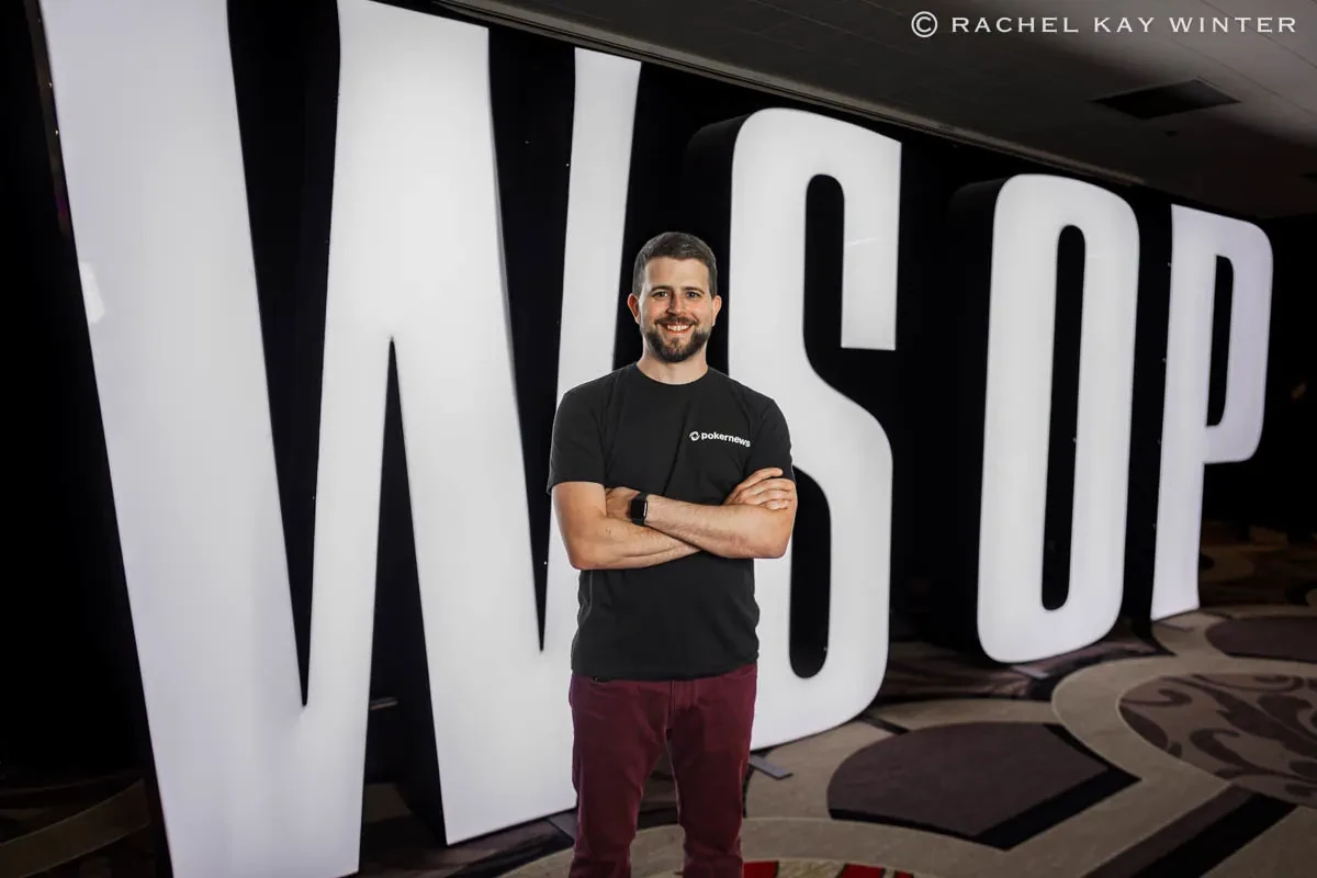 Keith Becker in PokerNews gear in front of a large WSOP sign